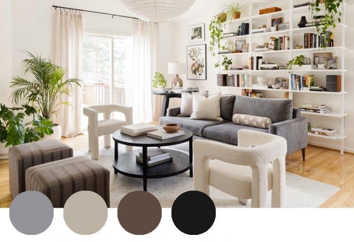 A cozy living room showcasing a neutral color palette of gray, cream, chocolate, and black, complemented by natural wood flooring, lush greenery, and a mix of textured furniture.
