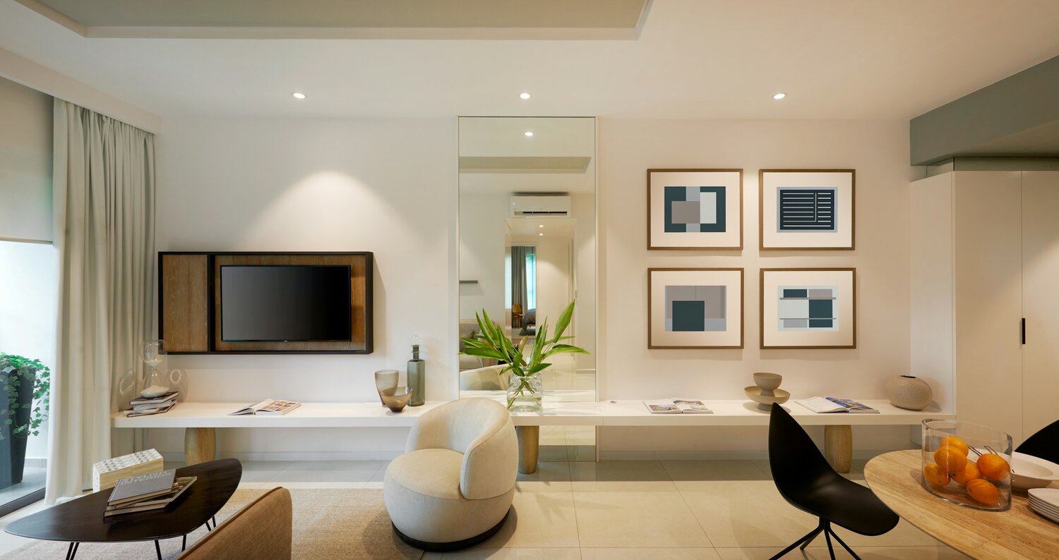 A sleek modern living room featuring dynamic lighting, with a blend of natural and artificial light highlighting a neutral color palette. The space includes a mounted TV, a minimalistic bench with decor, abstract wall art, and cozy furnishings.