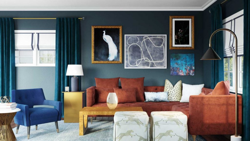 An eclectic living room featuring a rust-colored sectional sofa, a bold gallery wall, deep teal curtains, a vibrant blue accent chair, and a mix of textures and decor for a layered and cohesive look.
